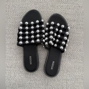 Pretty LittleThing Alisa Black Large Studded Slider Sandals with Silver Accents.